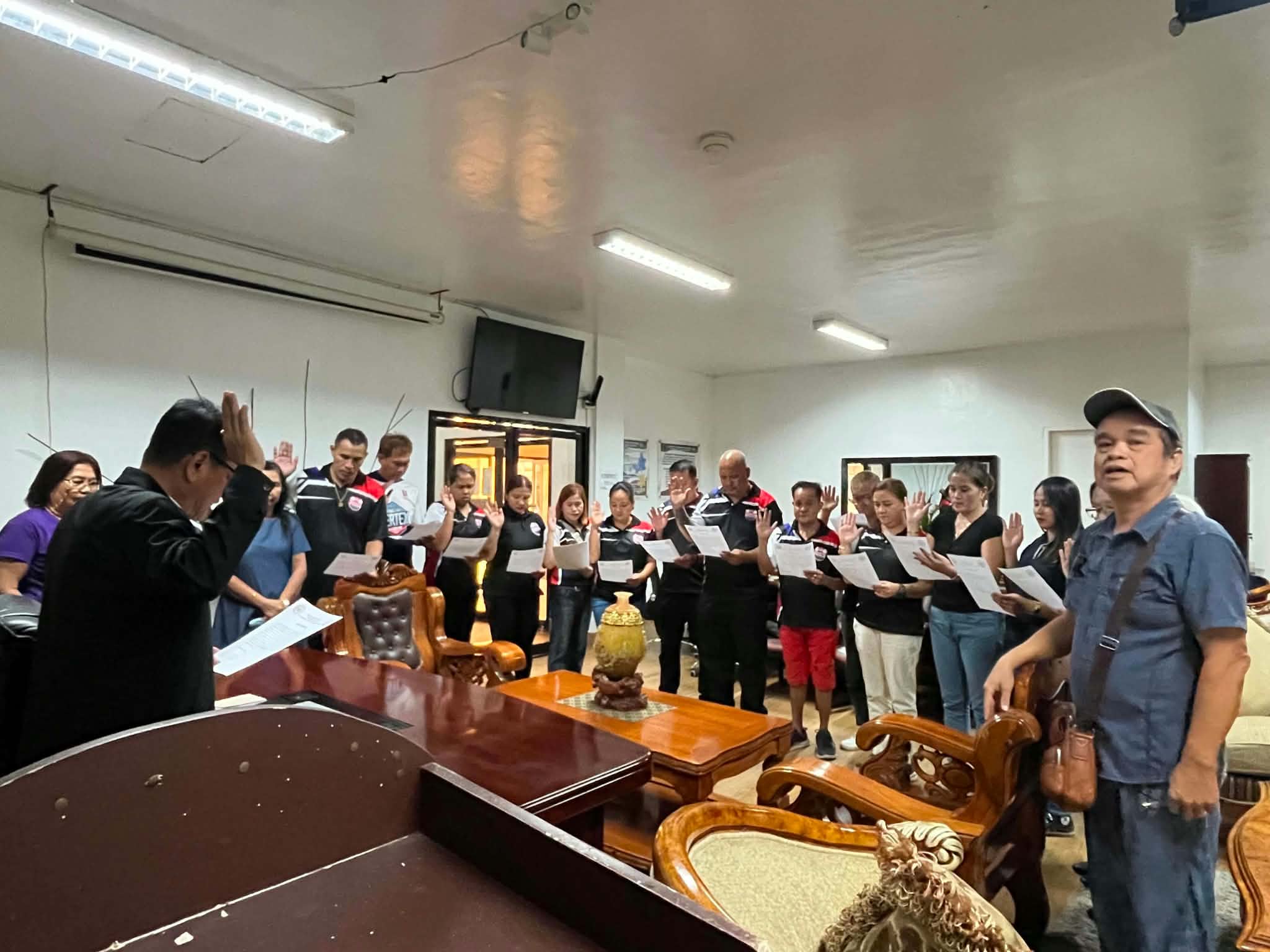 Association representatives raising their hands during an oath-taking at GMATHS