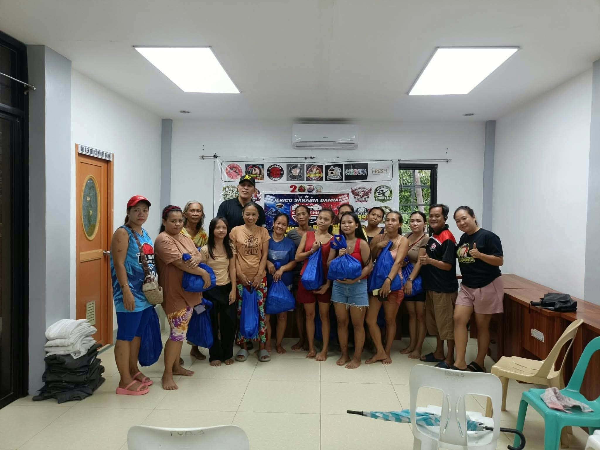 Group of community volunteers with bags of donations
